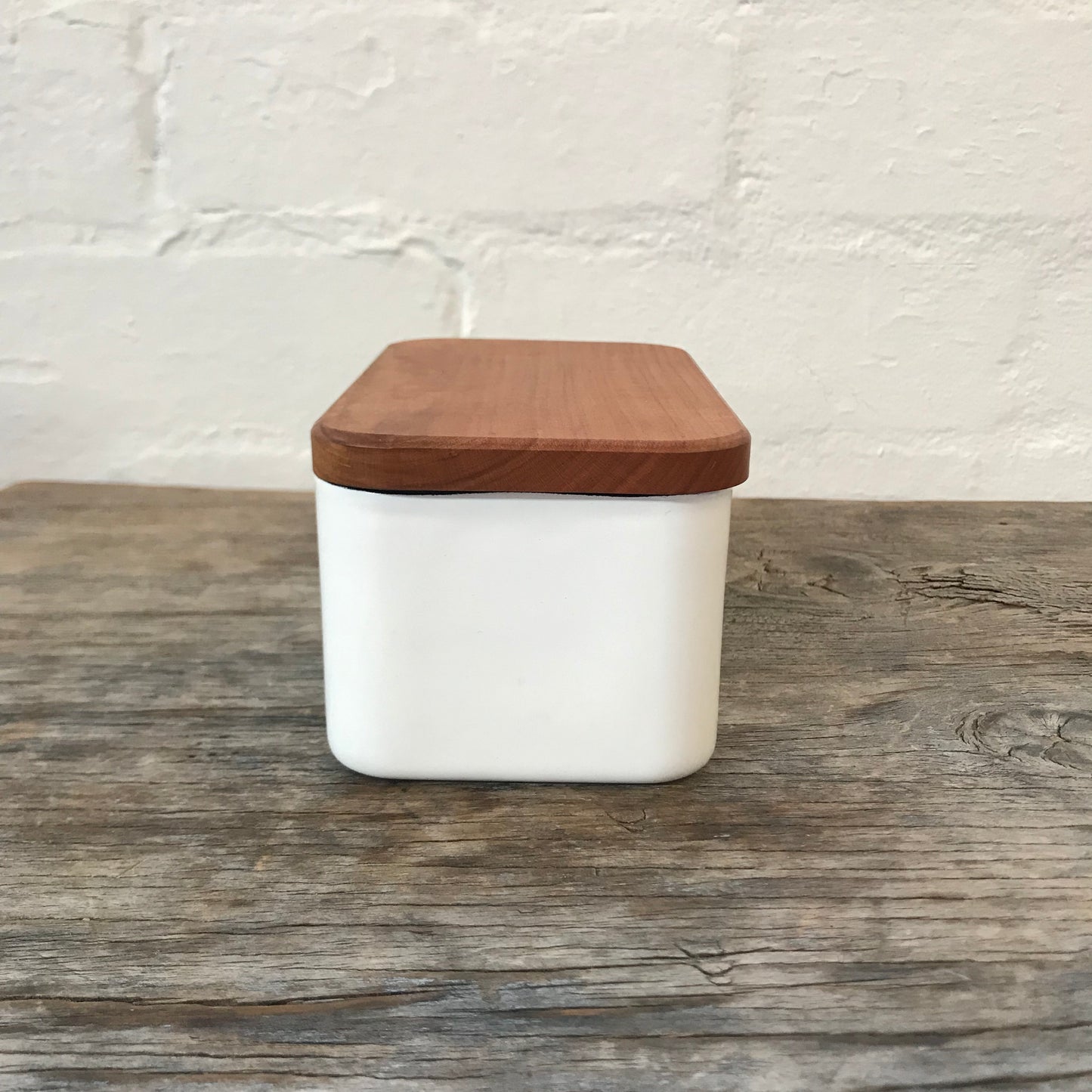 Noda Horo Enamel Butter Case L, a sleek white enamel container with a wooden lid for storing butter.