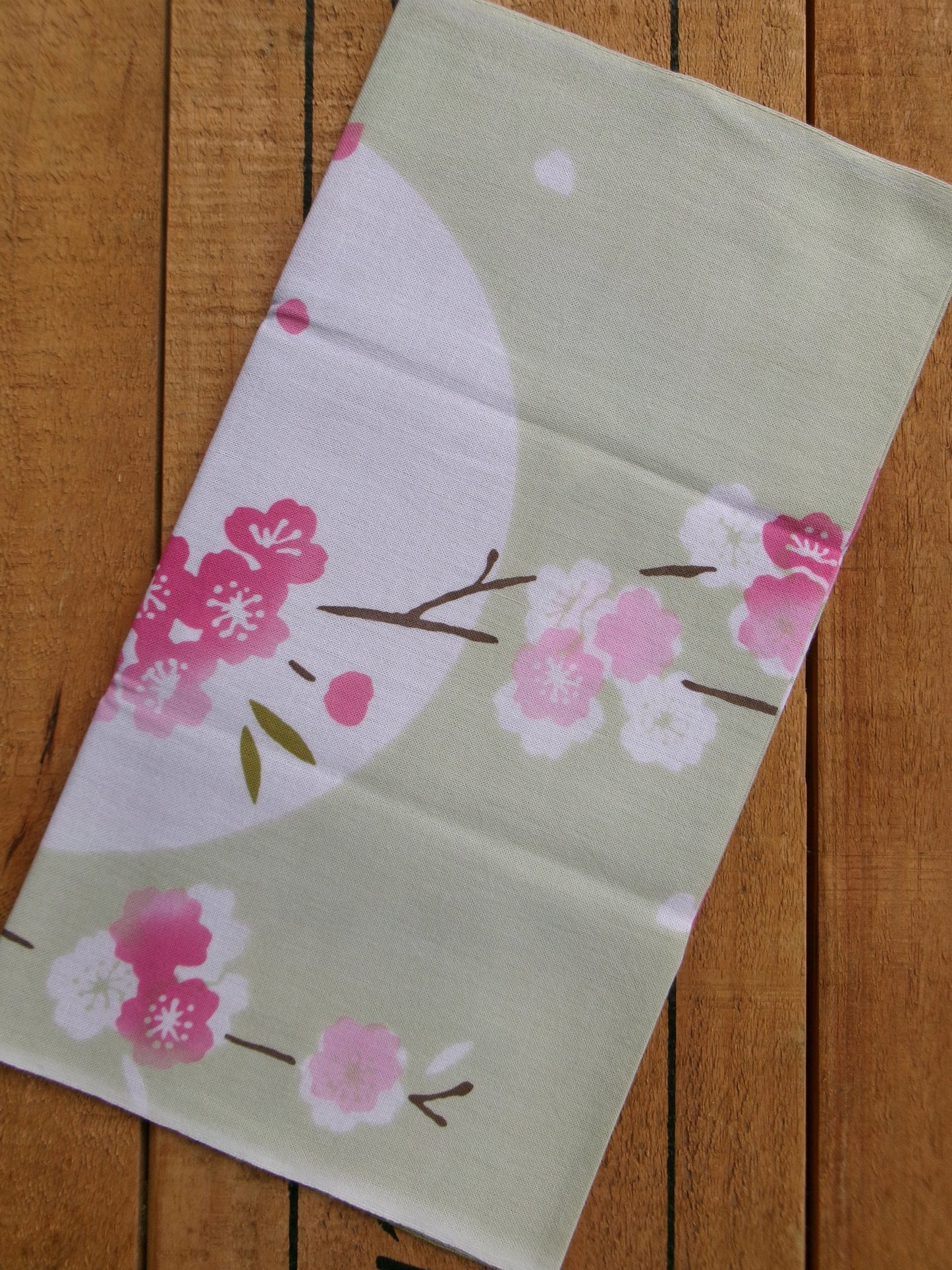 Japanese tenugui towel with cherry blossom and oboro pattern by Kamawanu, showcasing traditional fabric design and detailed floral print.