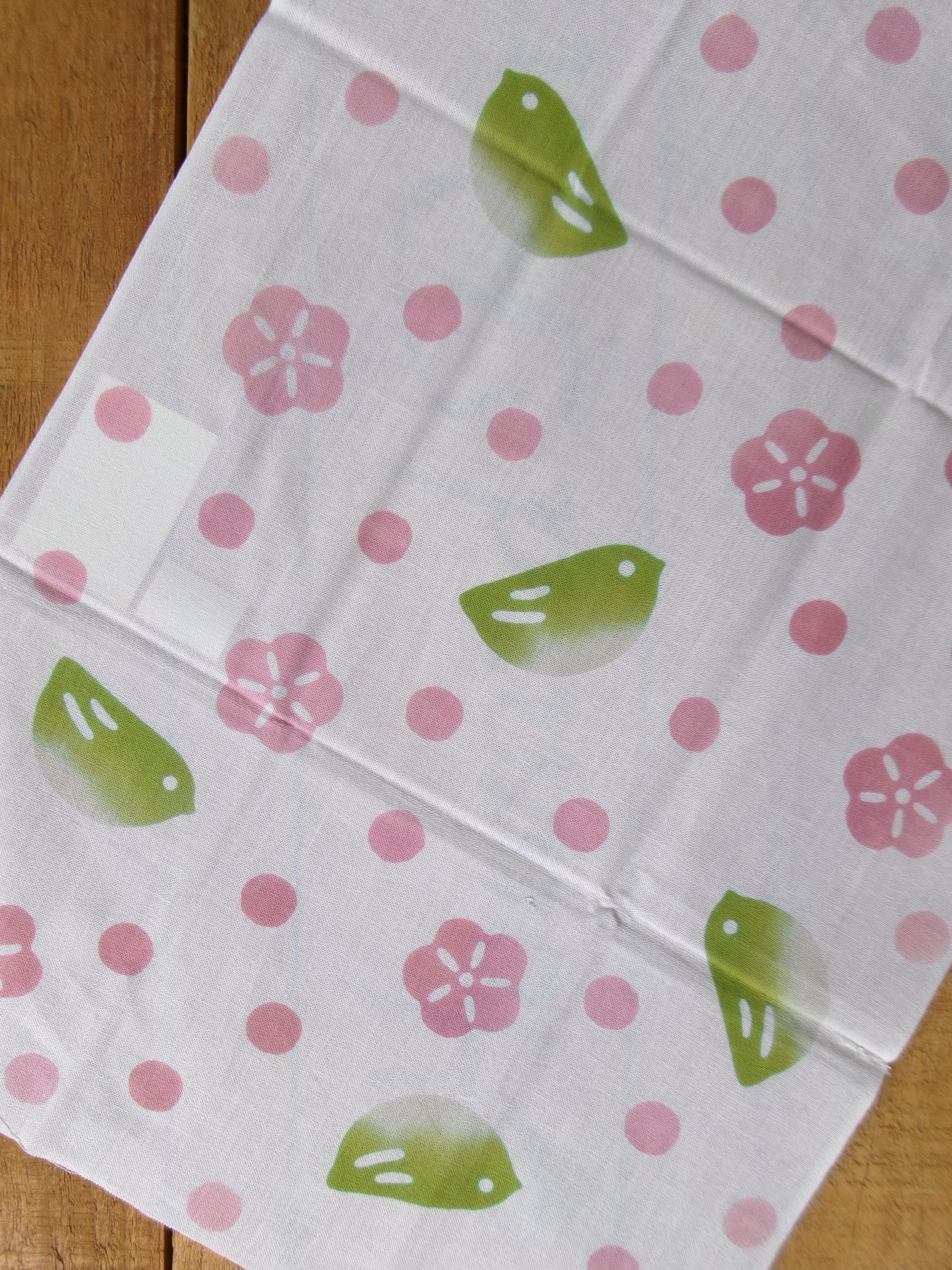 Cotton tenugui hand towel with green bulbul bird design by Kamawanu, featuring traditional Japanese patterns and soft fabric.