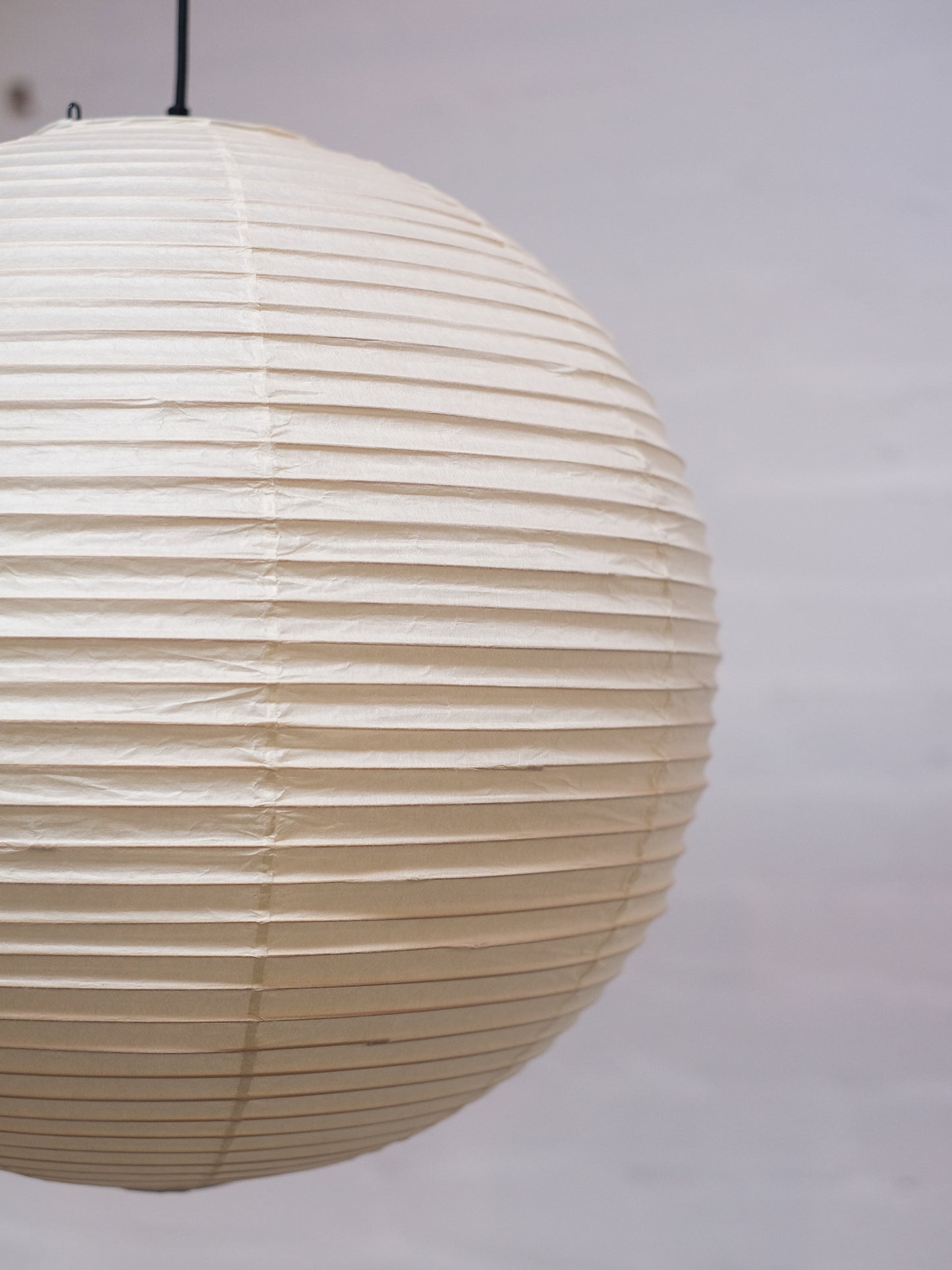 Akari 30A shade for light fixture, featuring a sleek, minimalist design in natural material with a smooth, curved shape.
