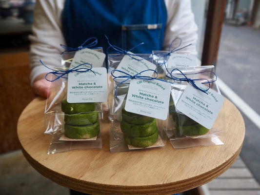 CIBI TOKYO STORE matcha and white chocolate cookies, three pieces on a plate, showcasing their green tea and white chocolate flavors.