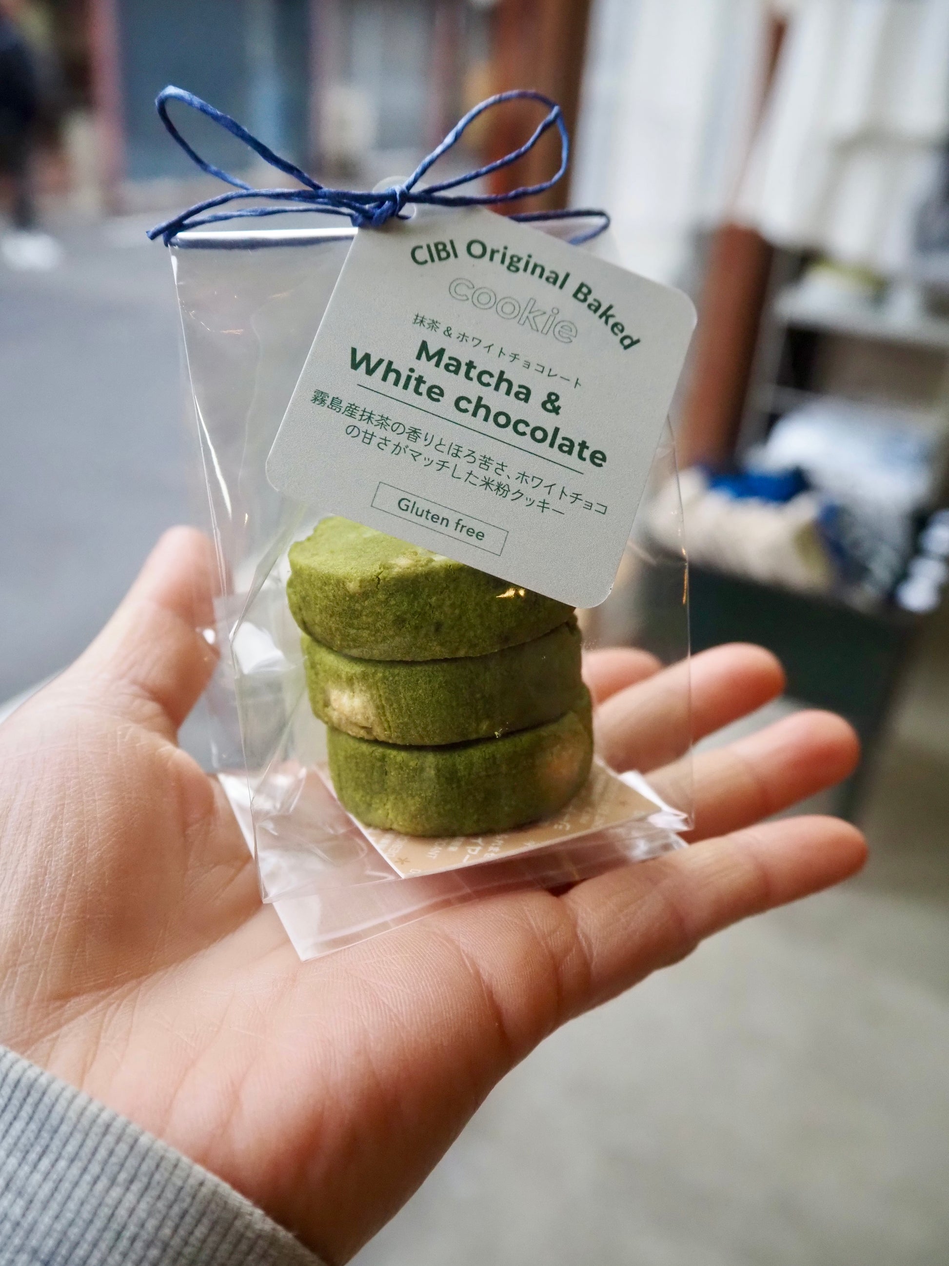 CIBI TOKYO STORE matcha and white chocolate cookies, three pieces on a plate, showcasing their green and white appearance.