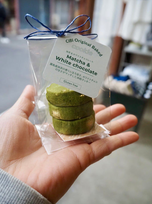 CIBI TOKYO STORE matcha and white chocolate cookies, three pieces on a plate, showcasing their green and white appearance.