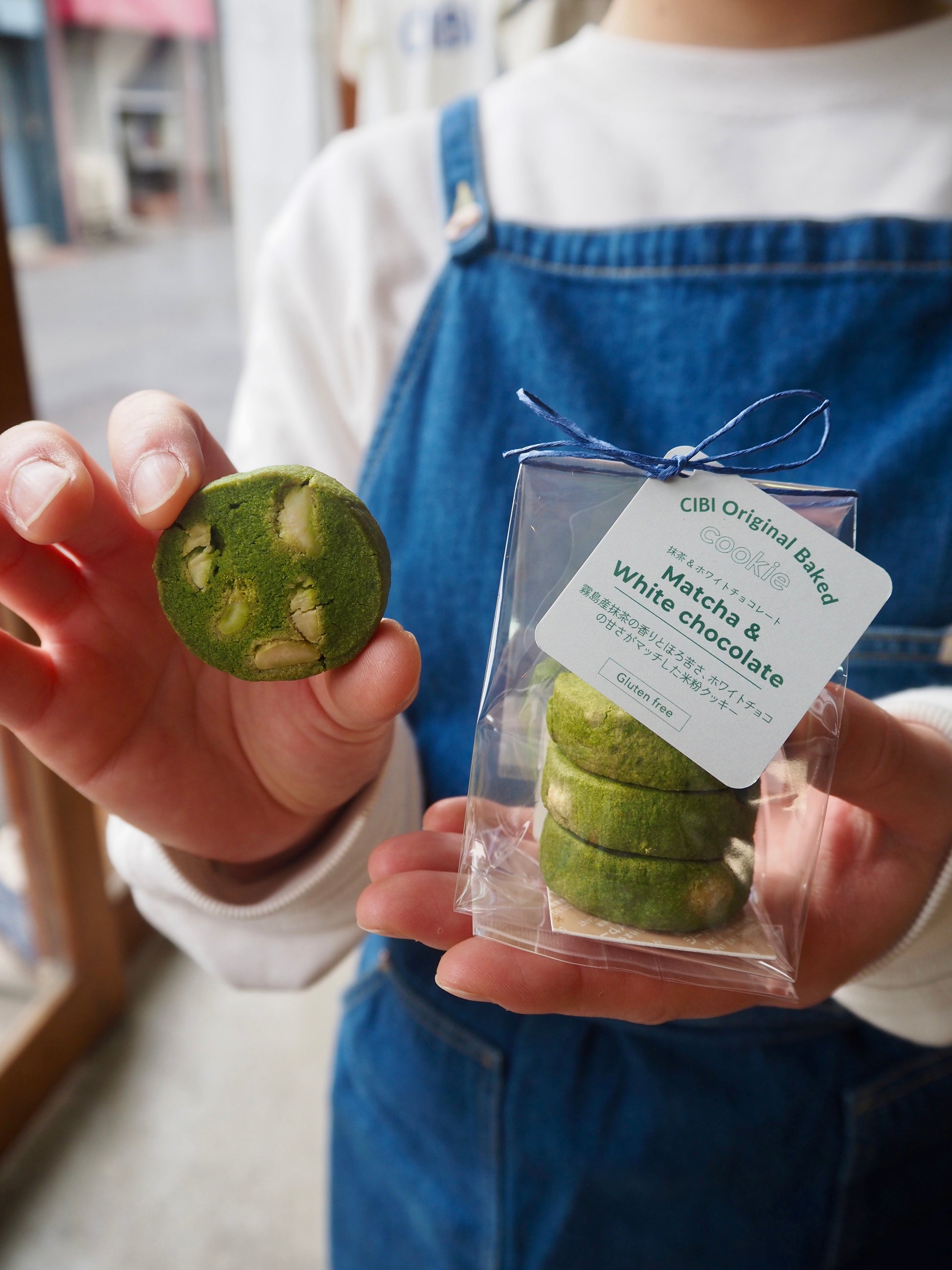 Three CIBI TOKYO STORE matcha and white chocolate cookies on a plate, showcasing their green tea and white chocolate filling.