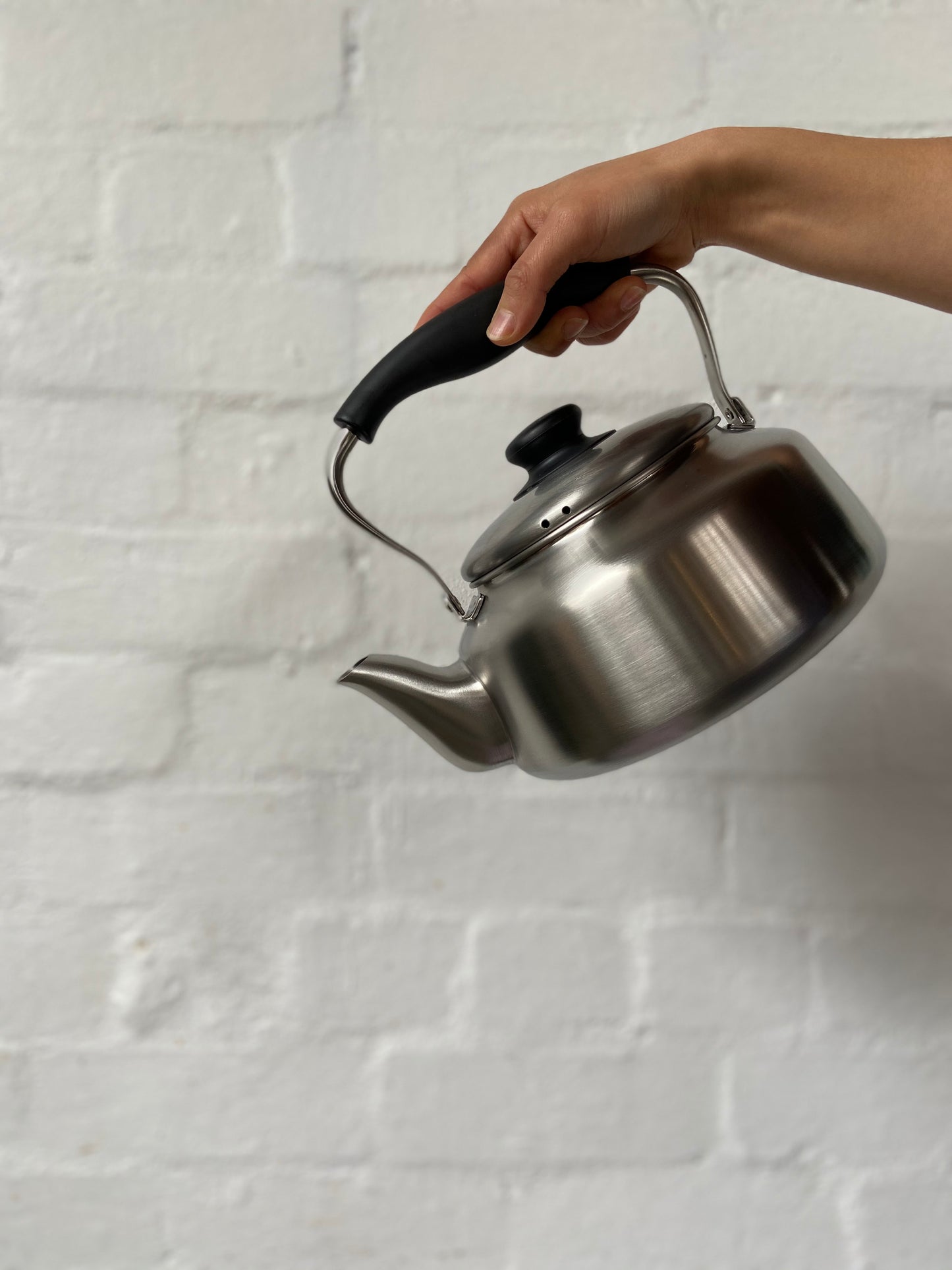 Sori Yanagi stainless steel kettle with matte finish, featuring a sleek handle and spout, designed for boiling water efficiently.