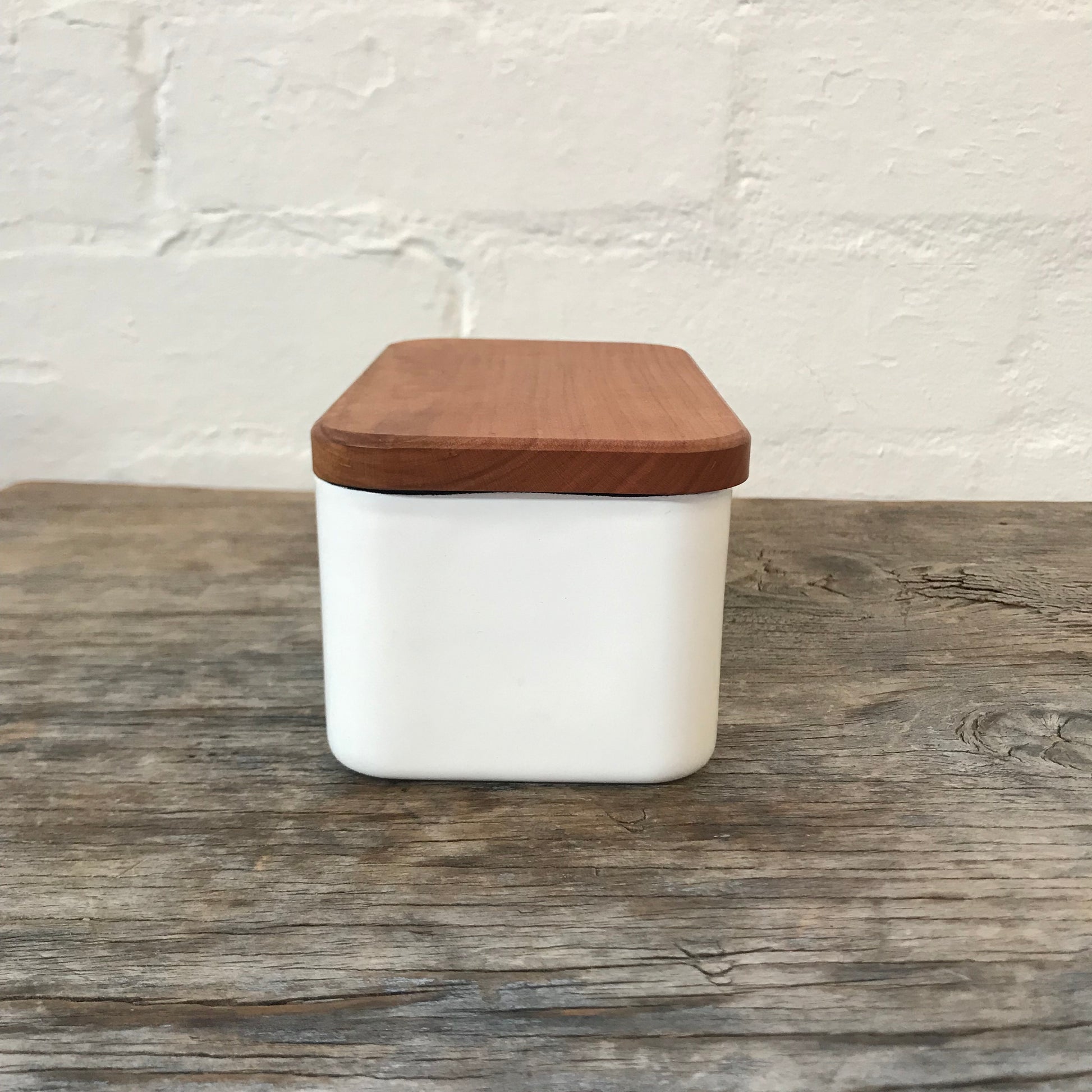 Noda Horo Enamel Butter Case L, a sleek white enamel container with a wooden lid for storing butter.