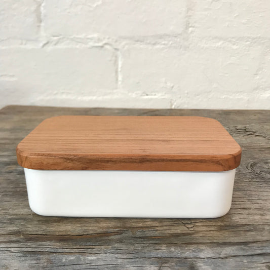 Noda Horo Enamel Butter Case M showing a sleek white enamel butter storage container with a lid on a kitchen countertop.