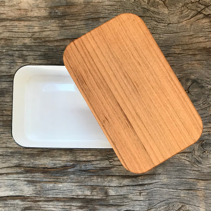 Noda Horo enamel butter case M with white lid and ceramic body, ideal for storing butter in a stylish kitchen.
