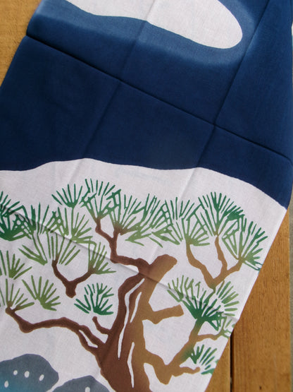 Traditional Japanese tenugui towel featuring Mount Fuji and hot springs design by Kamawanu, showcasing intricate blue and white patterns.