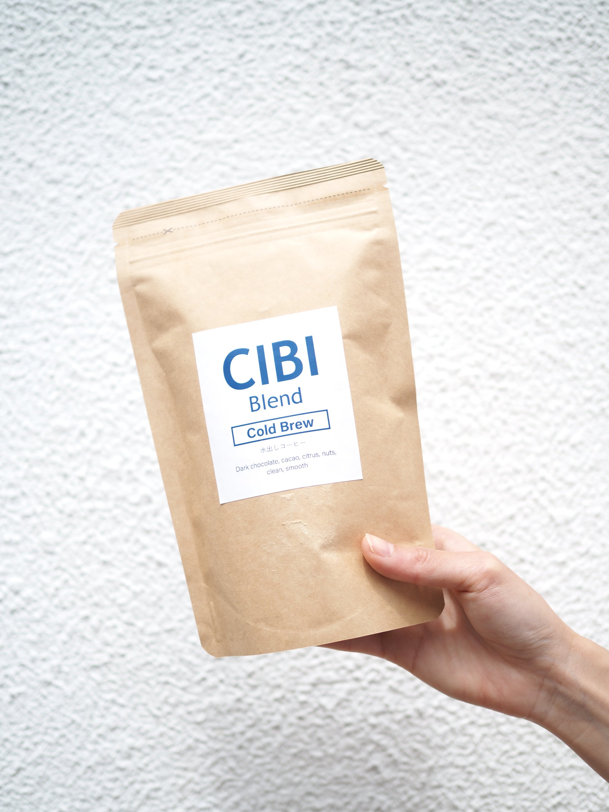 CIBI Cold Brew Coffee Pack with brewed coffee in a glass, showcasing a refreshing drink and coffee pack on a wooden table.