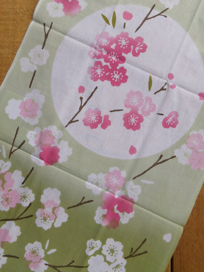 Cotton tenugui hand towel featuring sakura cherry blossom pattern by Kamawanu, showcasing traditional Japanese textile design.