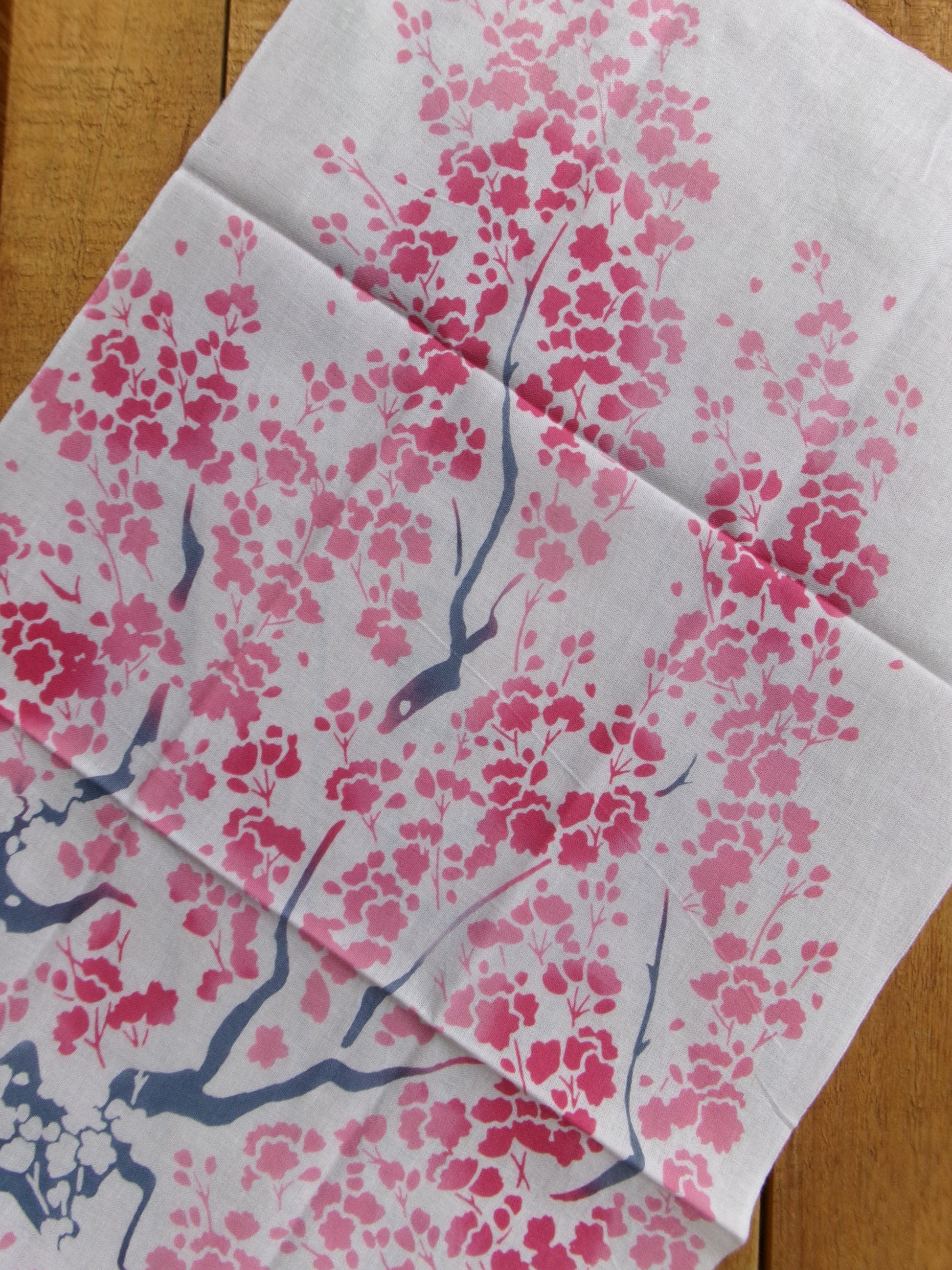 Colorful tenugui cloth featuring large cherry blossom (大桜) design by Kamawanu, showcasing traditional Japanese textile art.