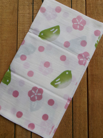 Japanese tenugui towel with traditional fukurau uguisu bird pattern by Kamawanu, featuring intricate blue and white design.