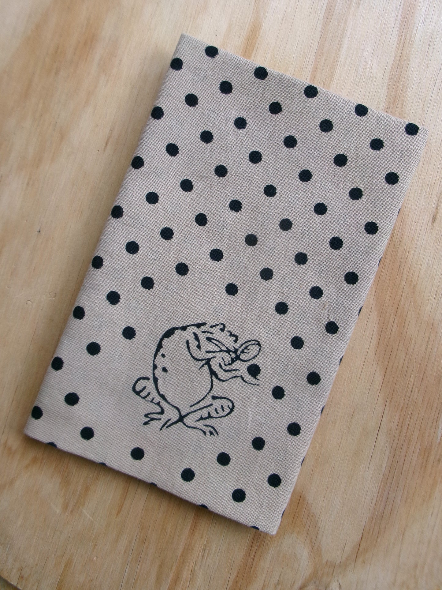 Beige small-pattern tengui towel featuring bird and beast caricature designs by Kamawanu, with traditional Japanese textile art.