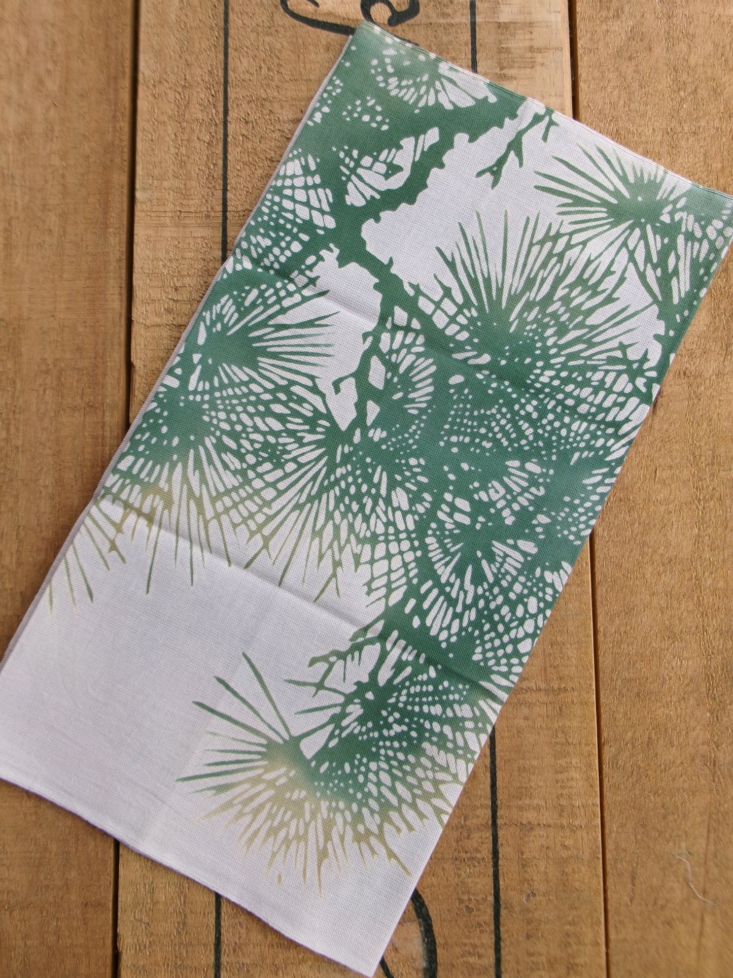 Traditional tenugui hand towel by Kamawanu featuring a blurred old pine tree design with soft, muted colors.