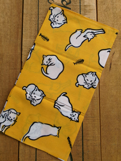 Japanese tenugui towel featuring playful cat patterns by Kamawanu, showcasing traditional fabric design with colorful feline motifs.