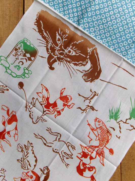 Cotton tenugui featuring colorful illustrations of birds and animals from the Chōjū-giga and goldfish motifs by Kamawanu.