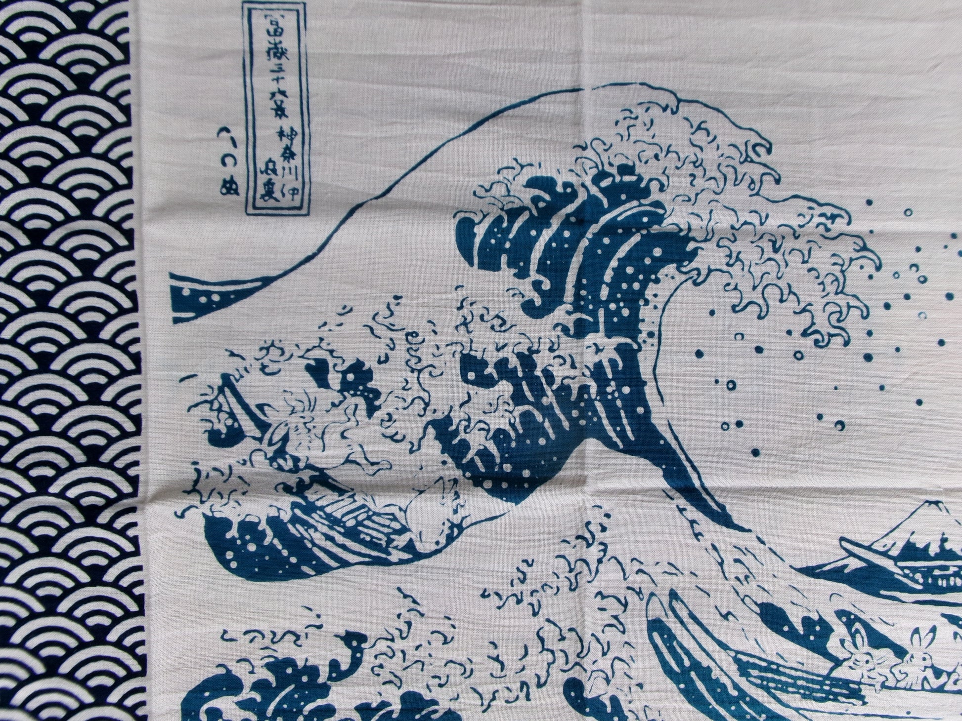 Japanese tenugui towel featuring Chōjū-giga and The Great Wave off Kanagawa designs by Kamawanu, traditional fabric art and print.