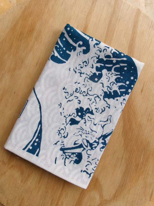 Cotton tenugui cloth featuring Chōjūgiga and The Great Wave off Kanagawa designs by Kamawanu, showcasing traditional Japanese artwork.