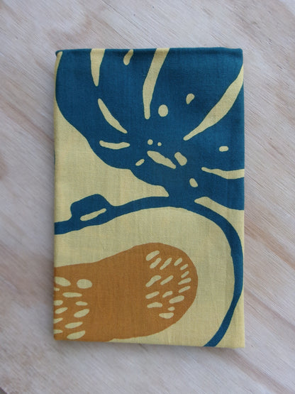 Cotton tenugui towel with a colorful pumpkin design by Kamawanu, featuring vibrant orange and green pumpkin illustrations.